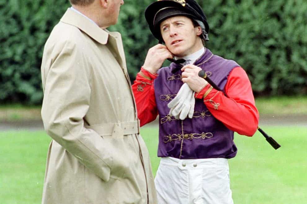 Lord Carnarvon the Queen’s racing manager talks to jockey Kieren Fallon before he rode Blueprint in the Geoffrey Freer Stakes at Newbury.