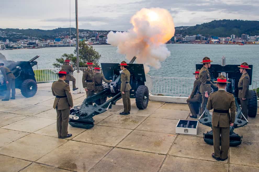 The Royal Regiment of New Zealand Artillery, using four 25-pounder guns, react during their 21-gun salute at Point Jerningham, to mark the 70th anniversary of the coronation of Queen, Elizabeth II, in Wellington, New Zealand (Mark Mitchell/NZME via AP)