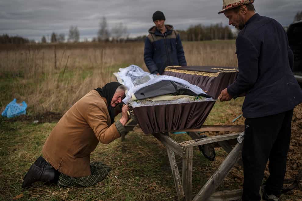 Nadiya Trubchaninova cries over the coffin of her son Vadym, who was killed on March 30 by Russian soldiers in Bucha, Ukraine, during his funeral in the cemetery of nearby Mykulychi, on the outskirts of Kyiv, on April 16 (Rodrigo Abd/AP)