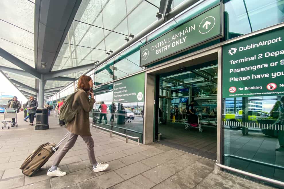 Passengers arrive at Dublin airport on Friday morning as around 200,000 people are set to travel through the airport over the bank holiday weekend (Damien Storan/PA)