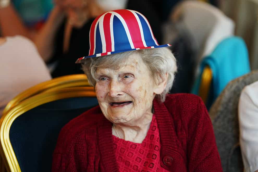 An elderly woman attends a Queen’s Platinum Jubilee tea dance at Belfast City Hall (Brian Lawless/PA)