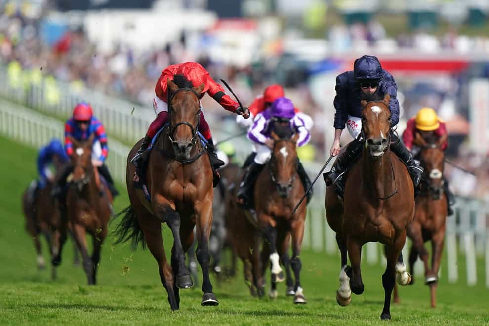 Tuesday ridden by Ryan Moore (right) leads Emily Upjohn ridden by Frankie Dettori (third left) to win the Cazoo Oaks during the Cazoo Derby Festival 2022 at Epsom Racecourse, Surrey. Picture date: Friday June 3, 2022.