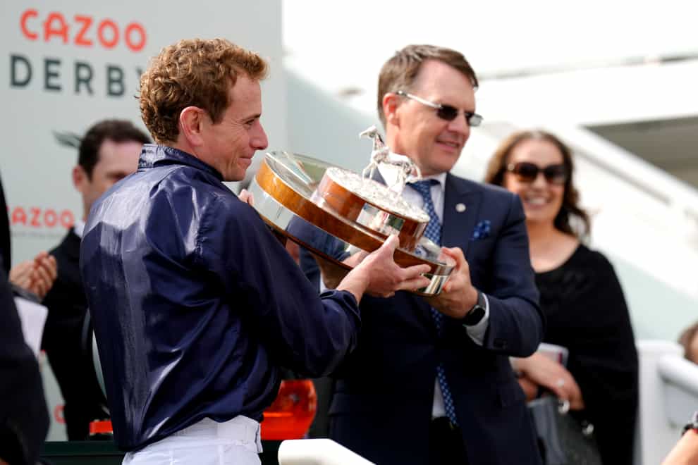 Jockey Ryan Moore (left) and trainer Aidan O’Brien celebrate with the trophy after Tuesday wins the Cazoo Oaks on Ladies Day during the Cazoo Derby Festival 2022 at Epsom Racecourse, Surrey. Picture date: Friday June 3, 2022.