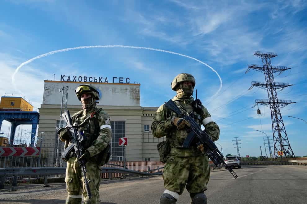 Russian troops guard an entrance of the Kakhovka Hydroelectric Station, a run-of-the-river power plant on the Dnieper River in Kherson region, southern Ukraine (AP)