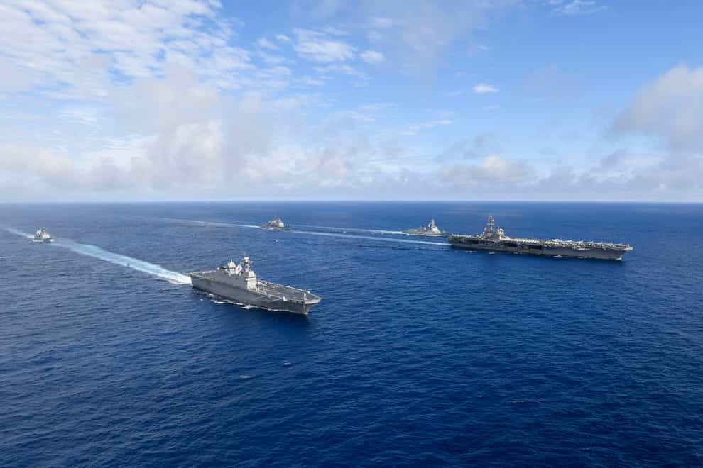 US nuclear-powered aircraft carrier USS Ronald Reagan, right, and South Korea’s landing platform helicopter (LPH) ship Marado, second from left, sail during a joint military exercise (South Korea Defence Ministry/AP)