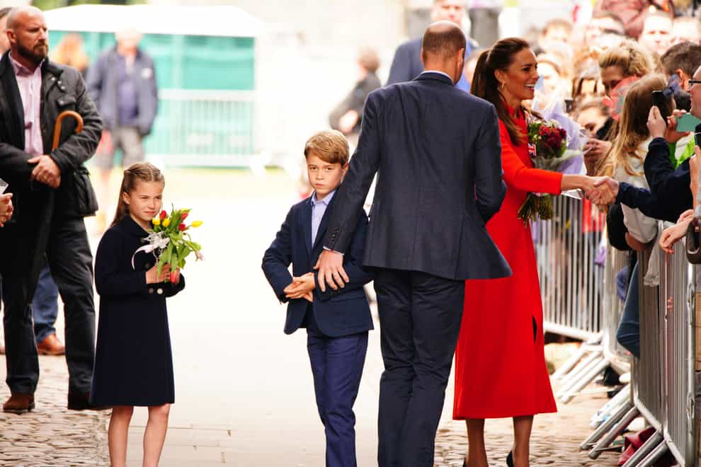 The Duke and Duchess of Cambridge, Prince George and Princess Charlotte speak to wellwishers during their visit to Cardiff Castle (Ben Birchall/PA)