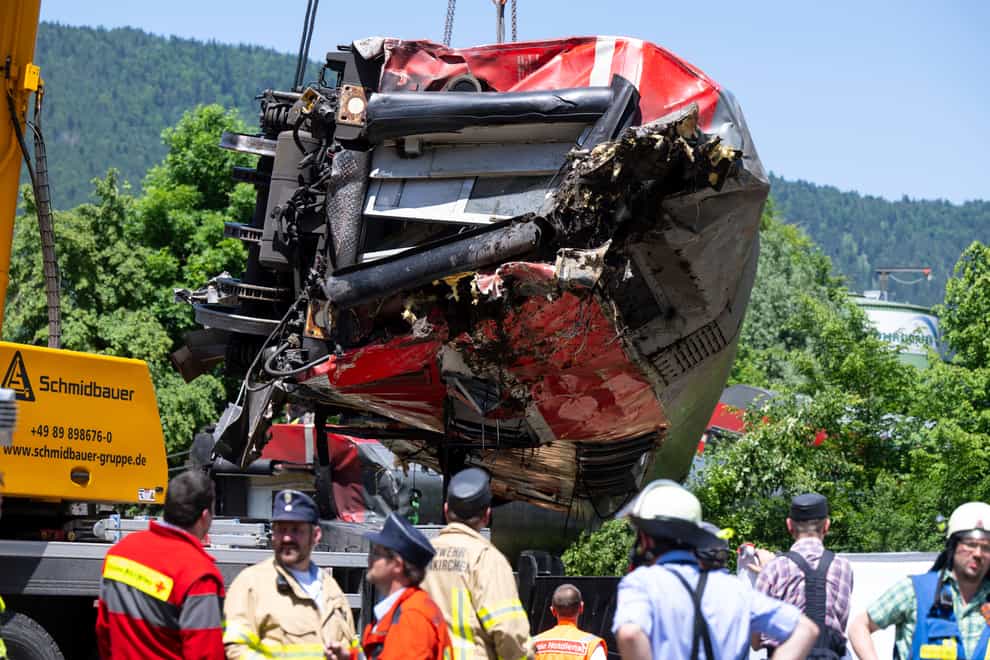 A carriage lifted at the site of a train crash in Burgrain, near Garmisch-Partenkirchen, Germany (Sven Hoppe/dpa/AP)
