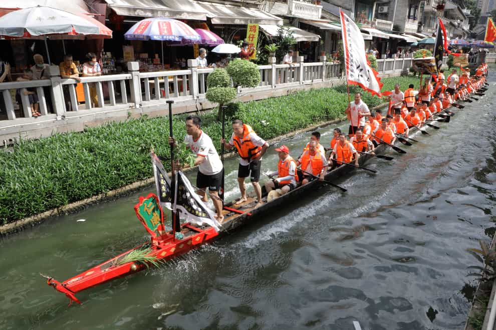 Dragon boat participants from Panting village row along a canal in the historic Lychee Bay scenic area in Guangzhou in southern China’s Guangdong Province (Caroline Chen/AP)