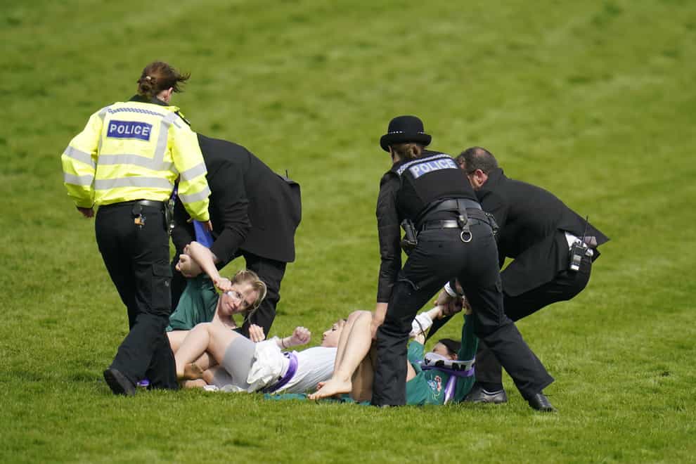 Protestors are removed from the racecourse ahead of the Derby (Andrew Matthews/PA)