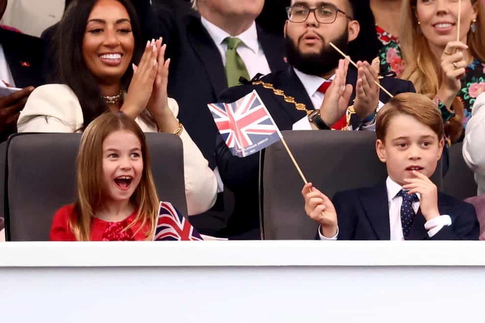 Charlotte, with George, reacts during the concert (Henry Nicholls/AP/PA)
