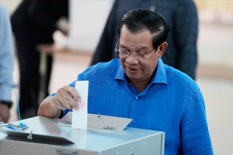 Prime Minister Hun Sen, of the Cambodian People’s Party, inserts his voting paper into a ballot box at a polling station in Takhmua in Kandal province, south-east of Phnom Penh (Heng Sinith/AP)
