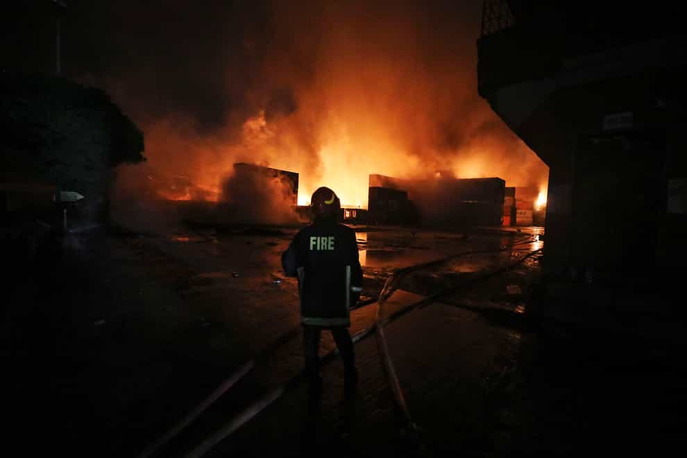 A firefighter works to contain a blaze at the BM Inland Container Depot (AP)