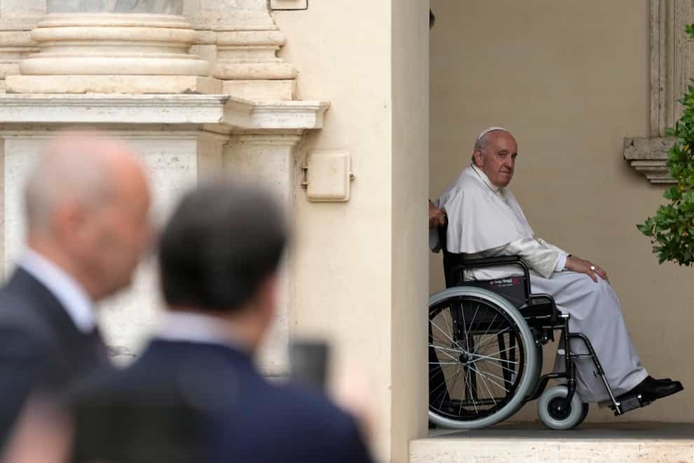 Pope Francis arrives in a wheelchair for an audience with children in the San Damaso courtyard at the Vatican (Alessandra Tarantino/AP)