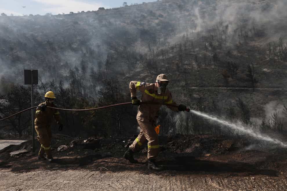 Firefighters tackle a wildfire in the Voula suburb in southern Athens, Greece (Yorgos Karahalis/AP)