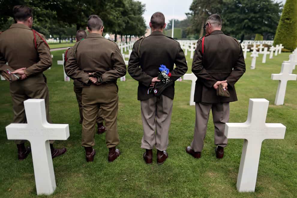 Second World War history enthusiasts pay their respects in the US cemetery at Colleville-sur-Mer, Normandy (Jeremias Gonzales/AP)