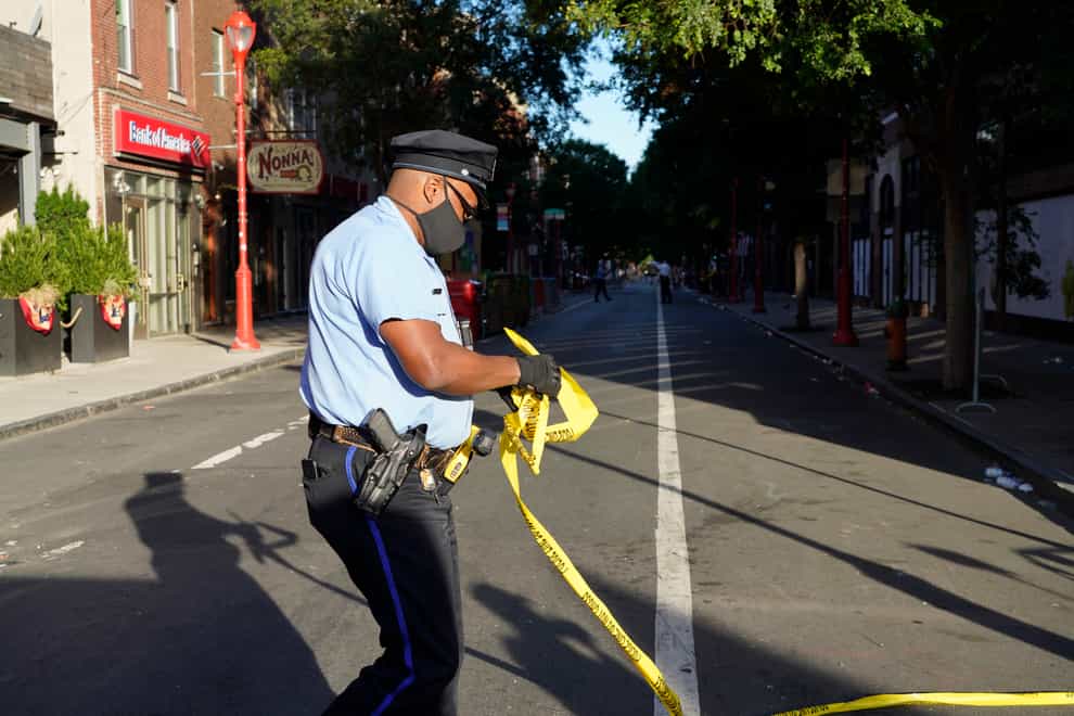 Investigators at the scene of a fatal shooting in Philadelphia (Michael Perez/AP/PA)