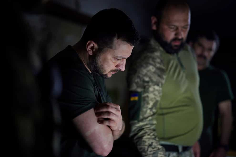 Ukrainian president Volodymyr Zelensky listens to a servicemen report close to the front line in Donetsk region (Ukrainian Presidential Press Office/AP)