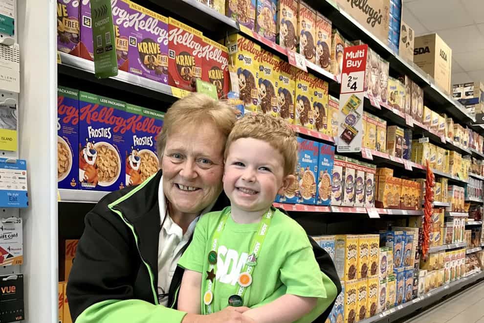 Three-year-old Hudson Wickens with store worker Mags Lunn, who has forged a remarkable friendship with the little boy (Asda/PA)