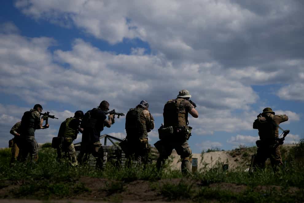 Civilian militia men hold shotguns during training at a shooting range in outskirts Kyiv, Ukraine (Natacha Pisarenko/AP)
