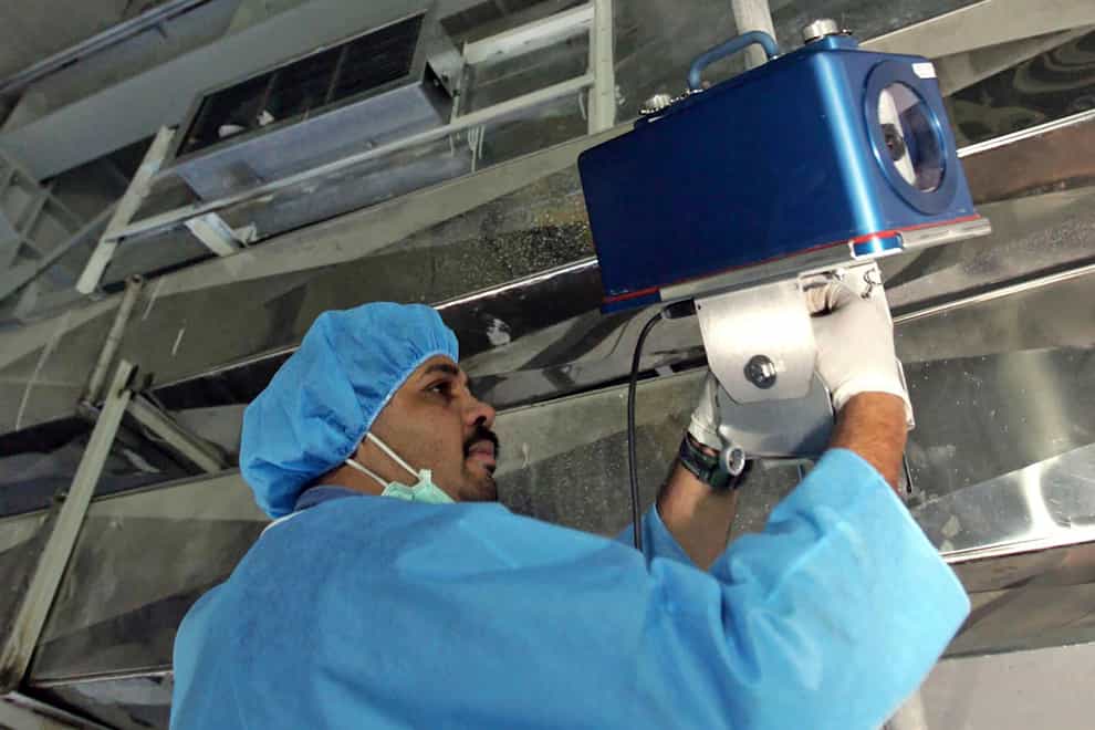 An International Atomic Energy Agency inspector sets up surveillance equipment at a uranium conversion facility in Iran (Mehdi Ghasemi, ISNA/AP)