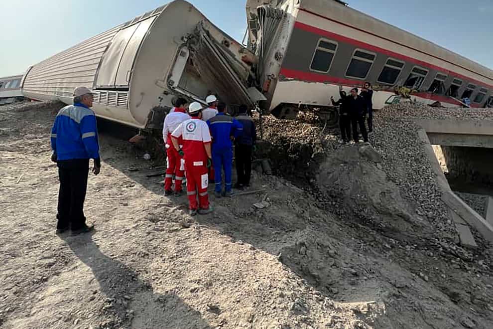 Rescuers work at the scene of the derailment in eastern Iran (Iranian Red Crescent Society via AP)