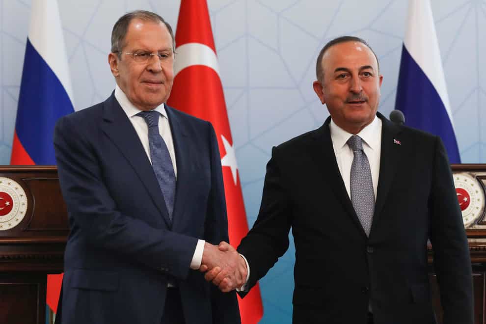 Russian foreign minister Sergey Lavrov, left, and Turkish foreign minister Mevlut Cavusoglu shake hands at the end of a joint news conference in Ankara (Burhan Ozbilici/AP)