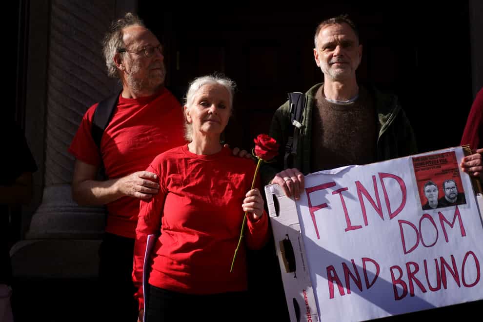 The family of Dom Phillips, left to right, Paul Sherwood, Sian Phillips and Gareth Phillips, take part in a vigil outside the Brazilian embassy in London (Victoria Jones/PA)