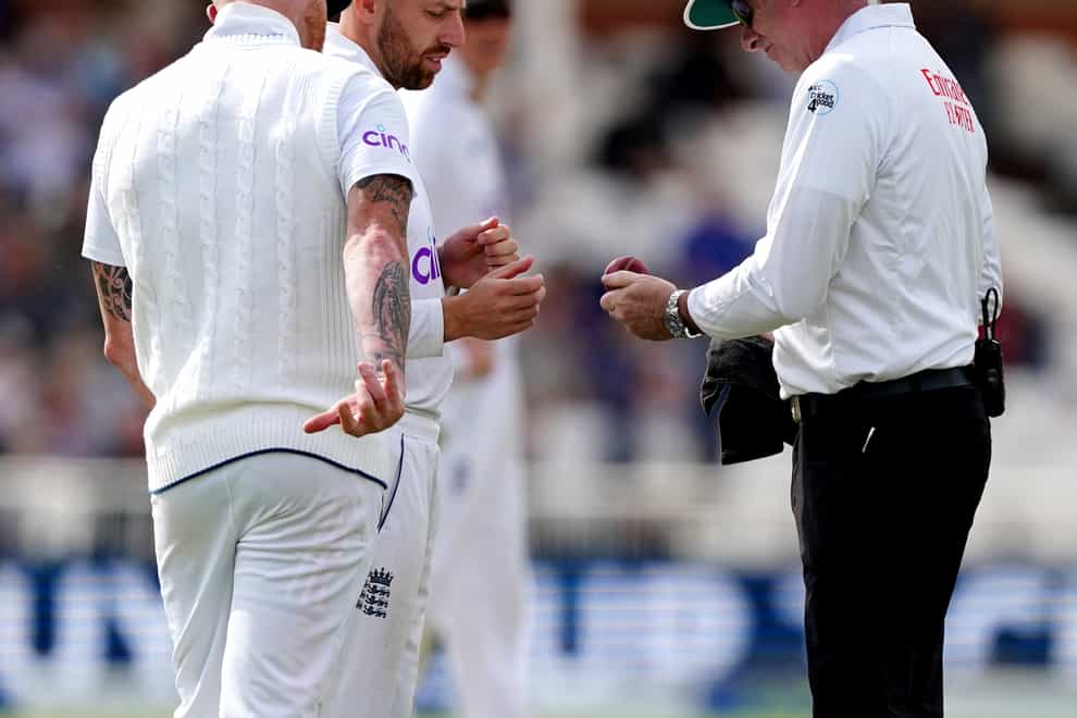 The umpire dries the ball off watched by England’s Jack Leach and Ben Stokes after the ball landed in a pint of beer during day one of the Second LV= Insurance Test Series at Trent Bridge, Nottingham. Picture date: Friday June 10, 2022.