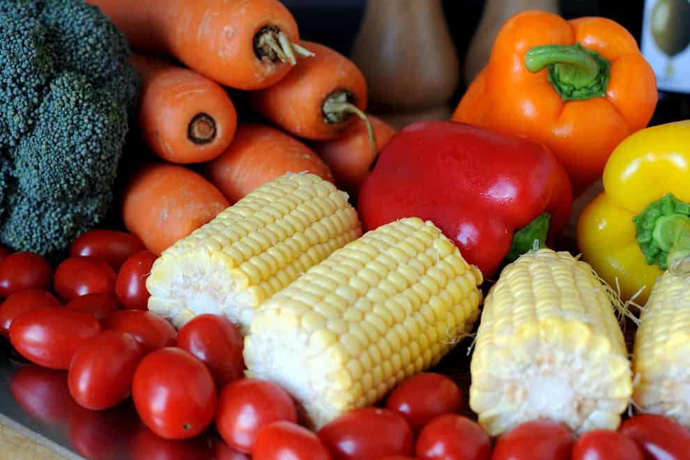Vegetable stock photo of baby plum tomatoes, corn cobs, red, yellow and orange peppers, broccoli and carrots (Nick Ansell/PA)