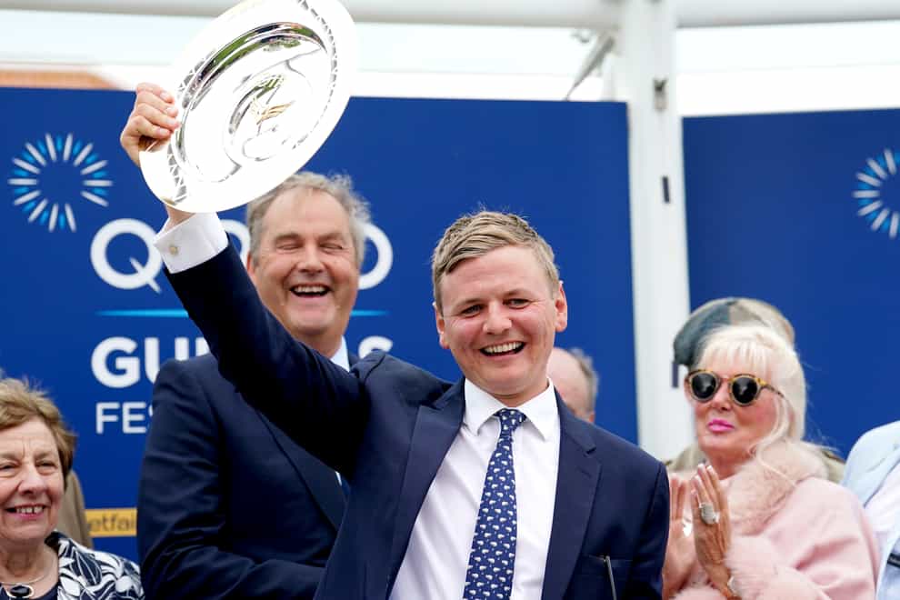 Trainer George Boughey celebrates with the trophy after Cachet ridden by jockey James Doyle wins the Qipco 1000 Guineas Stakes on day three of the QIPCO Guineas Festival at Newmarket Racecourse, Newmarket. Picture date: Sunday May 1, 2022.