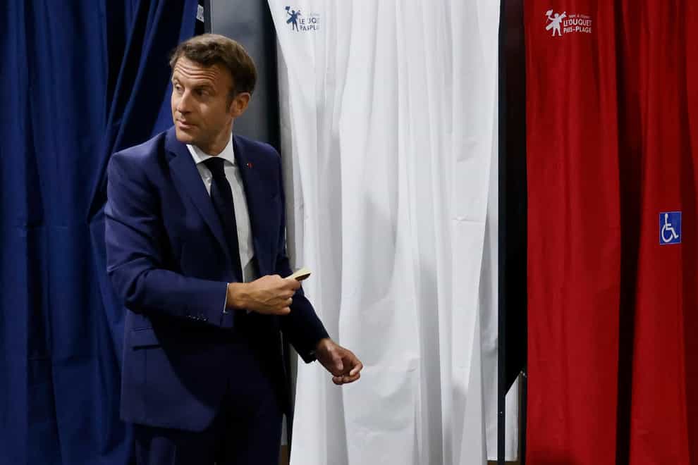 French President Emmanuel Macron at the voting booth in Le Touquet, northern France (Ludovic Marin/AP)