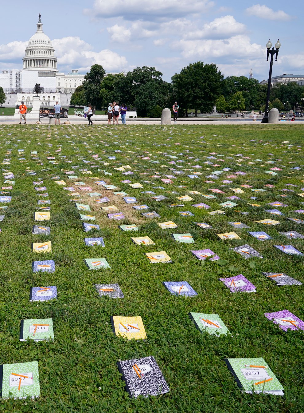 Thousands of schoolbooks and broken pencils, representing children killed by gun violence in the US, laid out near The Capitol (Susan Walsh/AP)