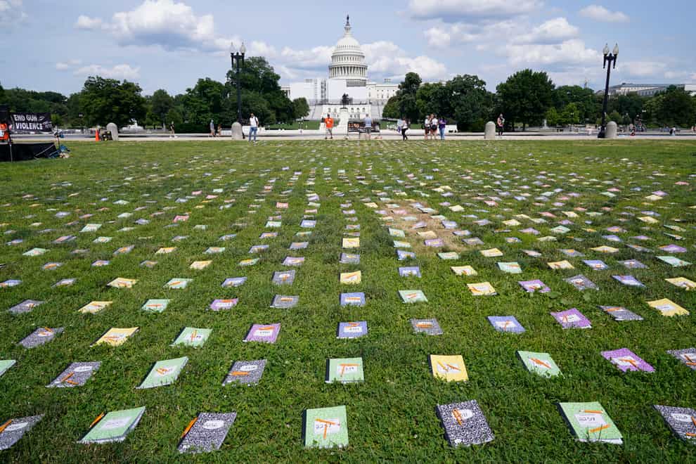 Thousands of schoolbooks and broken pencils, representing children killed by gun violence in the US, laid out near The Capitol (Susan Walsh/AP)