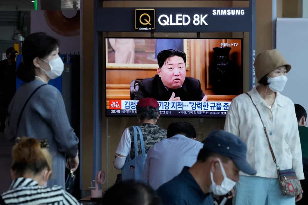 People watch a TV showing an image of North Korea leader Kim Jong Un at the Seoul Railway Station (AP)