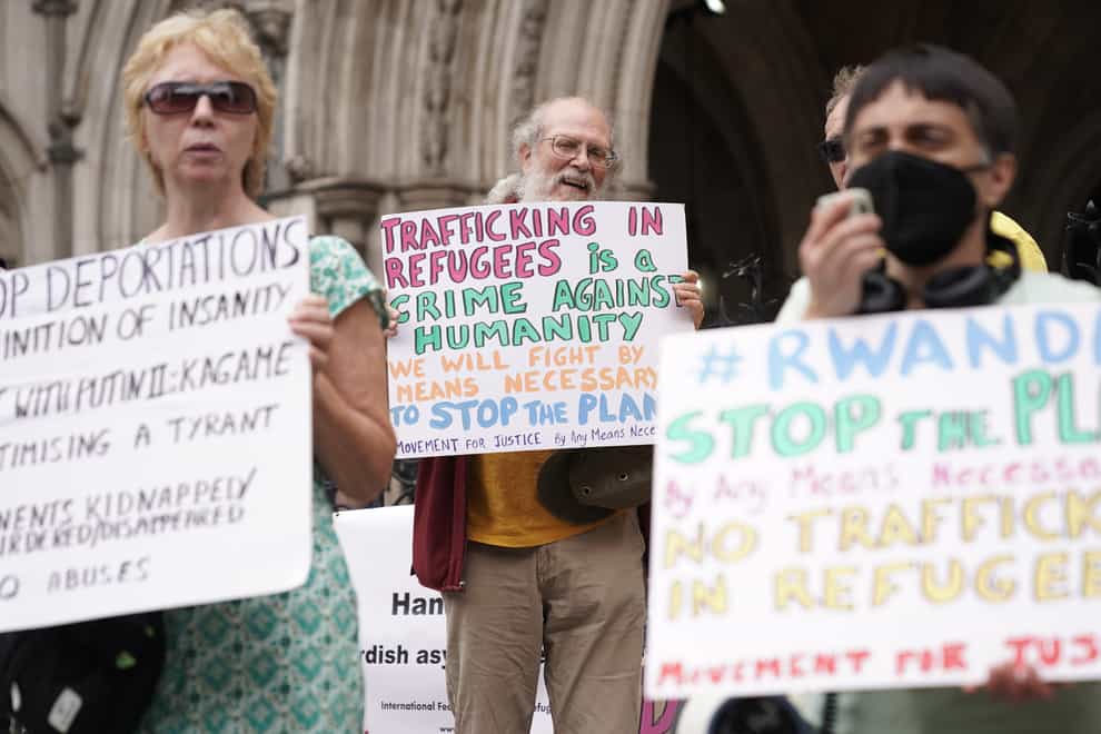 Protesters outside the High Court in London for the ruling on Rwanda deportation flights (PA)