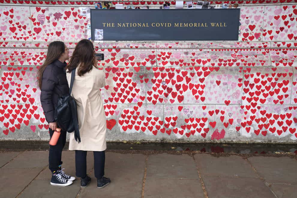 People at the Covid memorial wall in central London (Jonathan Brady/PA)