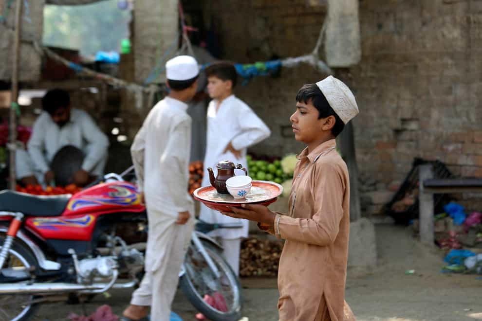 A boy at a tea shop in Peshawar, Pakistan (AP)