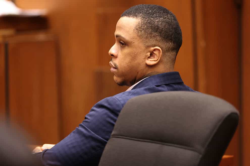 Defendant Eric Holder listens during opening statements in his murder trial (Frederick M. Brown/Daily Mail.com/AP)