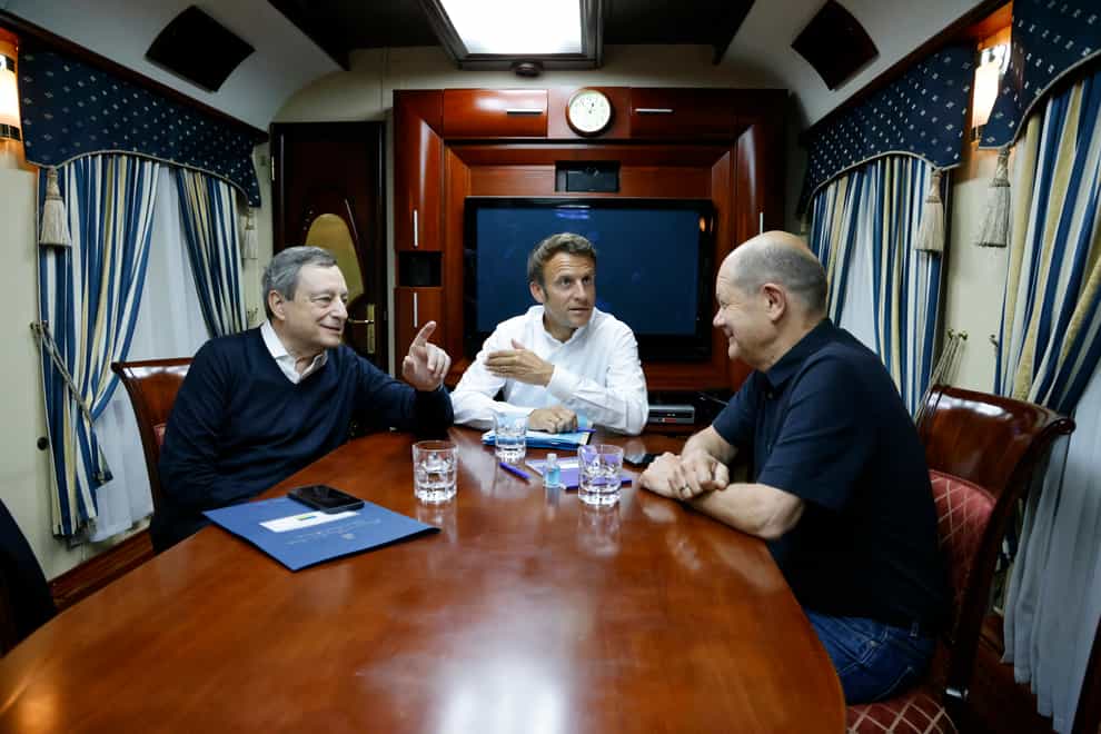 French President Emmanuel Macron, centre, German Chancellor Olaf Scholz, right, and Italian Prime Minister Mario Draghi travel on board a train bound to Kyiv after departing from Poland (Ludovic Marin/AP)