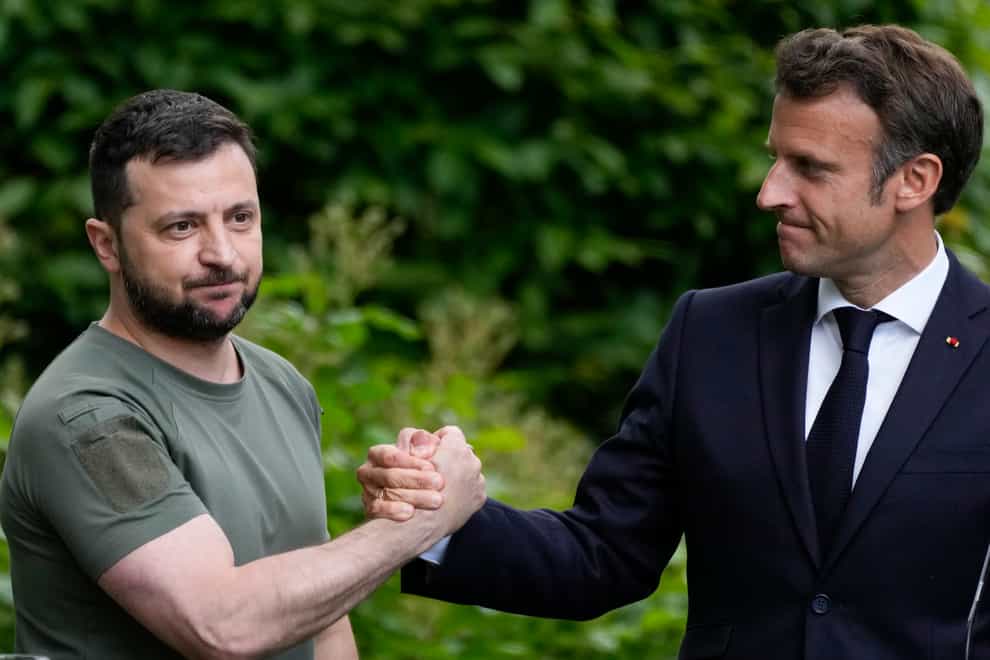 Volodymyr Zelensky, left, and Emmanuel Macron shake hands at the end of a press conference in Kyiv (AP Photo/Natacha Pisarenko)
