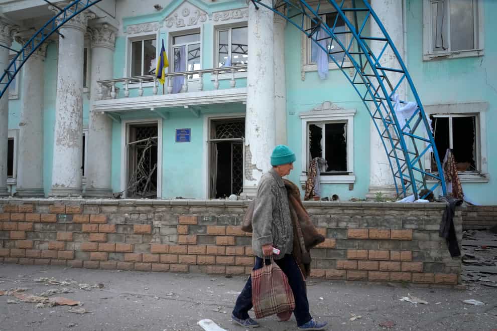 A woman passes by a building destroyed in the Russian shelling in Lysychansk, in the Luhansk region of Ukraine (Efrem Lukatsky/AP/PA)