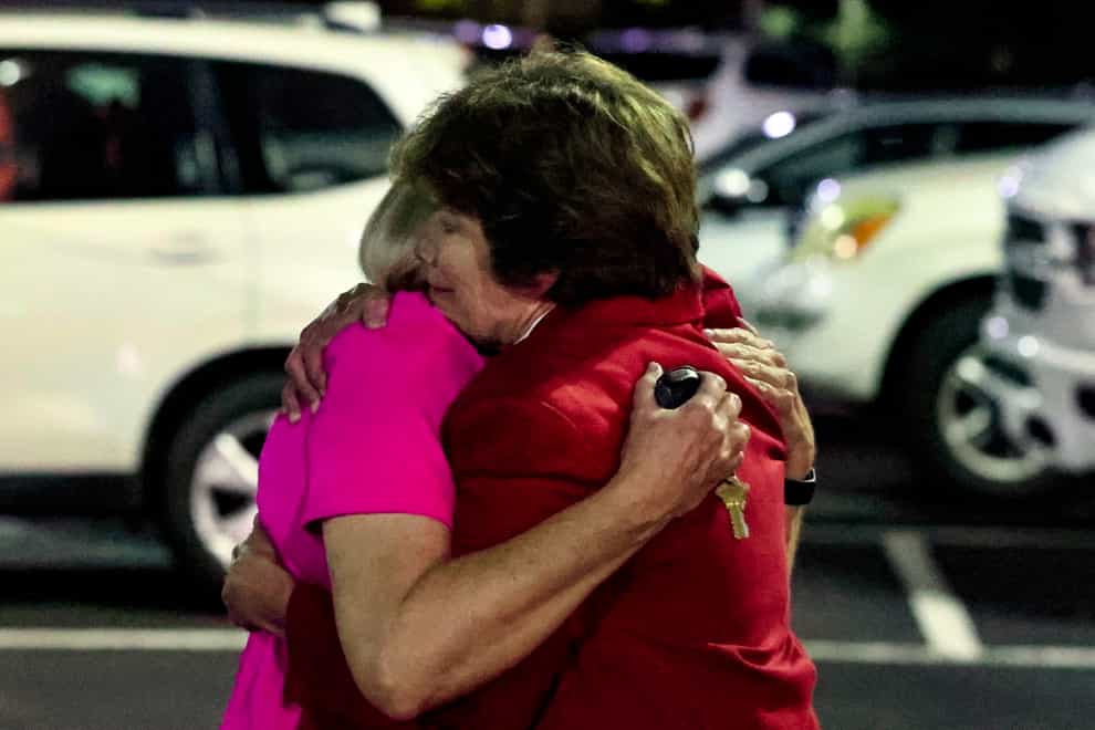 Church members console each other after a shooting at the Saint Stevens Episcopal Church in Alabama (AP Photo/Butch Dill)