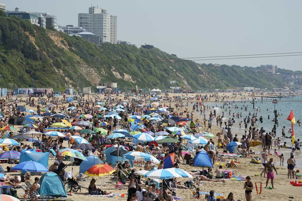 People enjoy the warm weather on Bournemouth beach in Dorset (Andrew Matthews/PA)