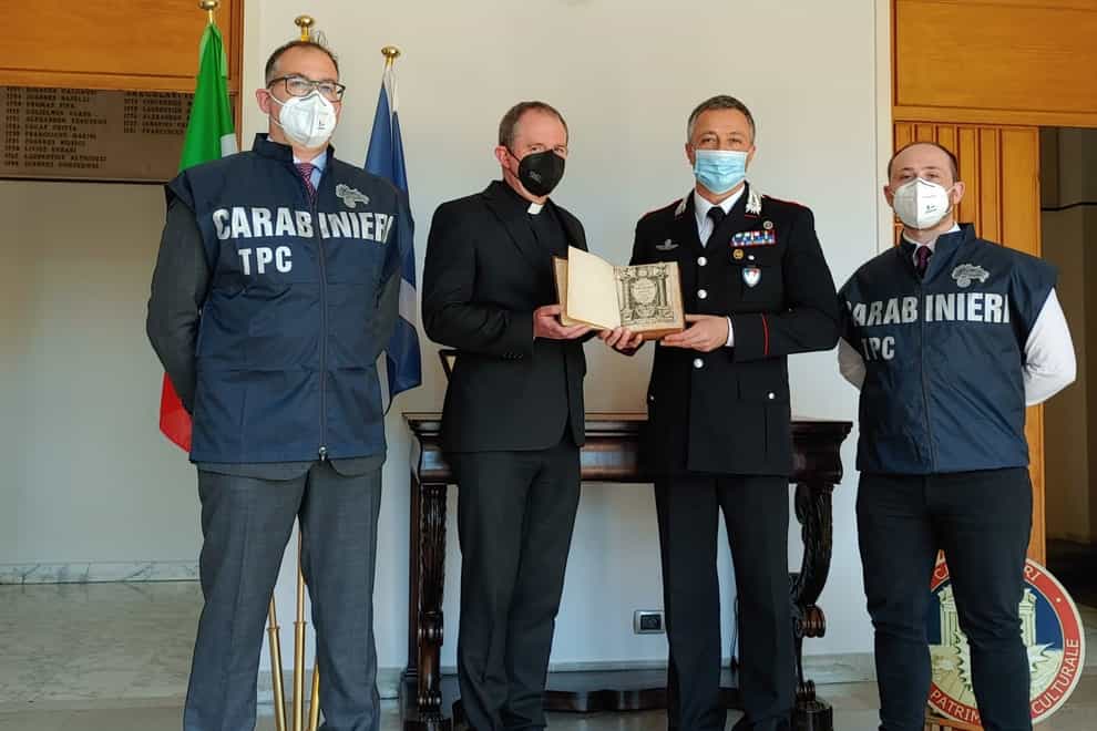 Officers from the Carabinieri returned the book to the Scots College in Rome, before it was then brought back to Scotland (Police Scotland/PA)