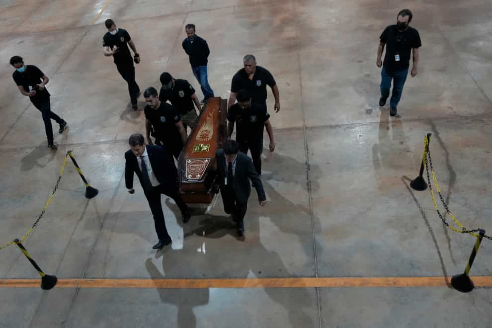 Police with recovered human remains in Brasilia, Brazil (Eraldo Peres/AP)