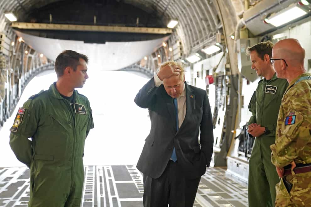Boris Johnson with aircrew on board a C17, after arriving at RAF Brize Norton following a surprise visit to Kyiv (Joe Giddens/PA)