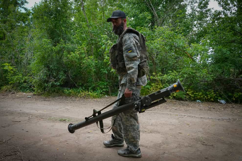 A Ukrainian soldier carries a US-supplied Stinger as he goes along the road in Ukraine’s eastern Donetsk region (Efrem Lukatsky/AP)