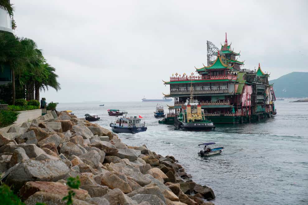 Hong Kong’s iconic Jumbo Floating Restaurant is towed away in Hong Kong on June 14 (AP)