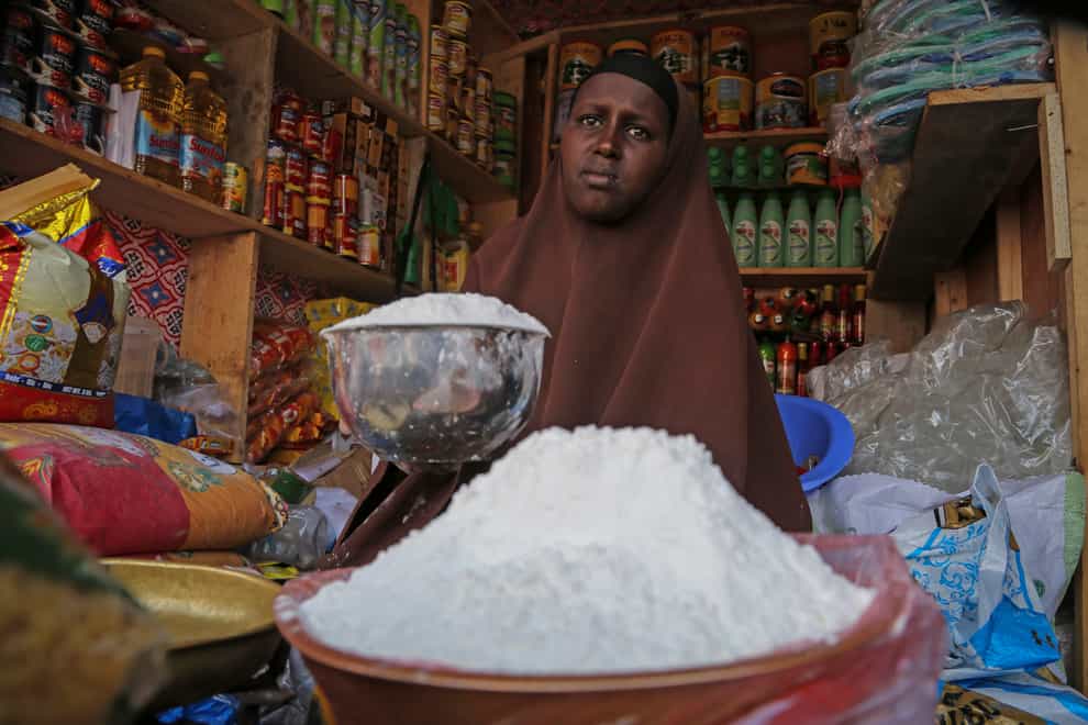 A shopkeeper sells wheat flour in the Hamar-Weyne market in Mogadishu, Somalia (AP)