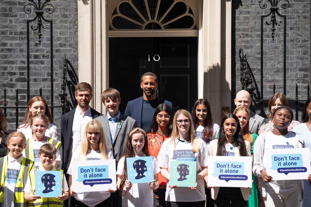 Rio Ferdinand poses for photographs with children at 10 Downing Street to celebrate the launch of the Diana Award’s annual anti-bullying campaign Don’t Face It Alone (Stefan Rousseau/PA)